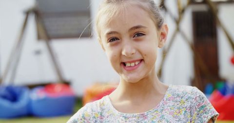 Joyful Girl Playing Outdoors with Spoon and Egg