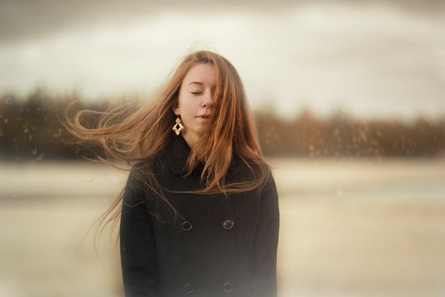 Woman Standing Outdoors with Windswept Hair - Download Free Stock Photos Pikwizard.com