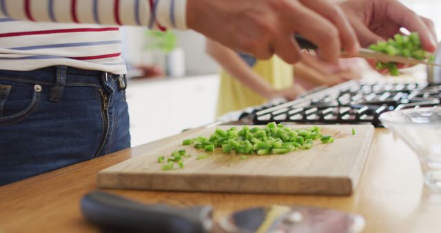 People Neatly Chopping Green Bell Peppers in Modern Kitchen - Download Free Stock Images Pikwizard.com