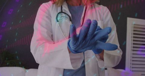 Female healthcare professional wearing blue protective gloves in clinic