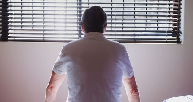 Elderly Person Looking Out Window, Contemplative Mood in Serenity - Download Free Stock Images Pikwizard.com