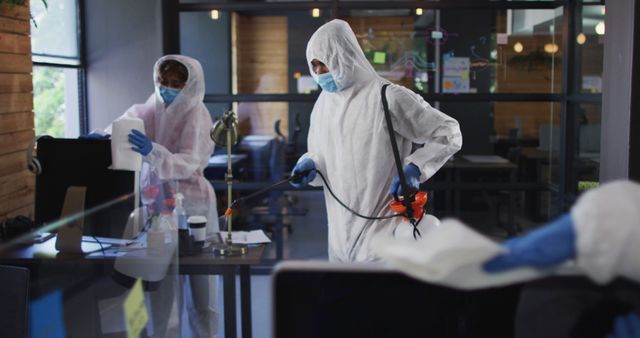 Professional Cleaners in Hazmat Suits Sanitizing Office Space - Download Free Stock Images Pikwizard.com