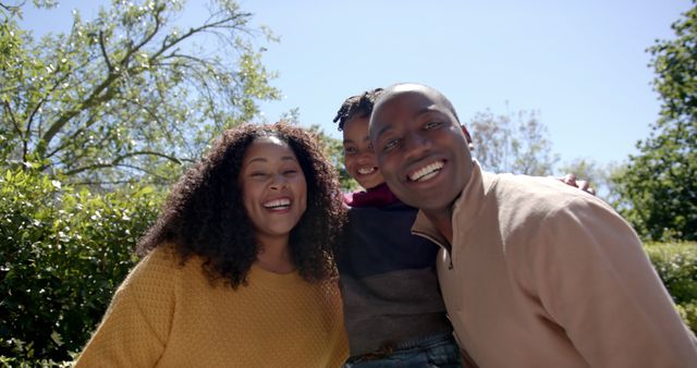 Smiling Family Posing Outdoors on Sunny Day - Download Free Stock Images Pikwizard.com