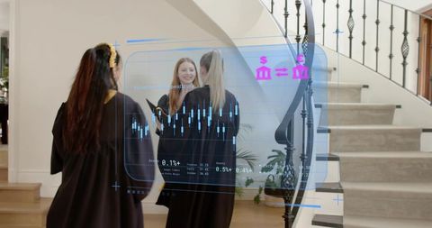 Graduates standing and chatting with holographic financial charts overlay in elegant foyer