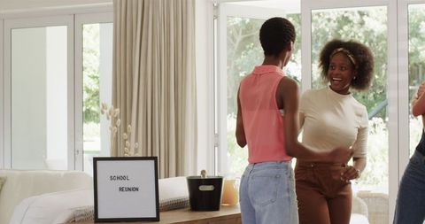 Cheerful Friends Dancing at Home During Reunion Celebration