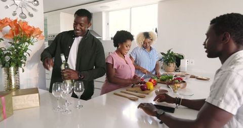 Group of Friends Preparing Food Together in Modern Kitchen Setting