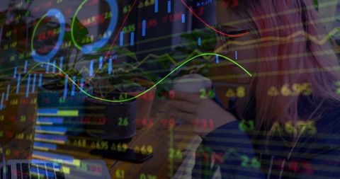 Remote trader analyzing market charts while sipping coffee in coworking café with laptop