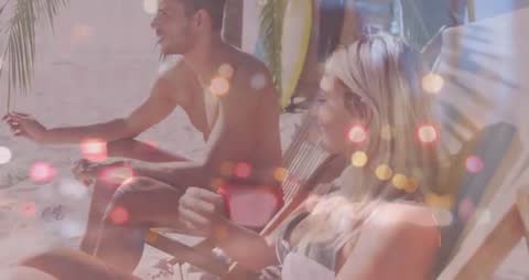 Couple Relaxing on Beach with Relaxing Bokeh Overlay