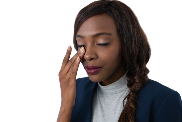 Close up of businesswoman rubbing eyes against white background