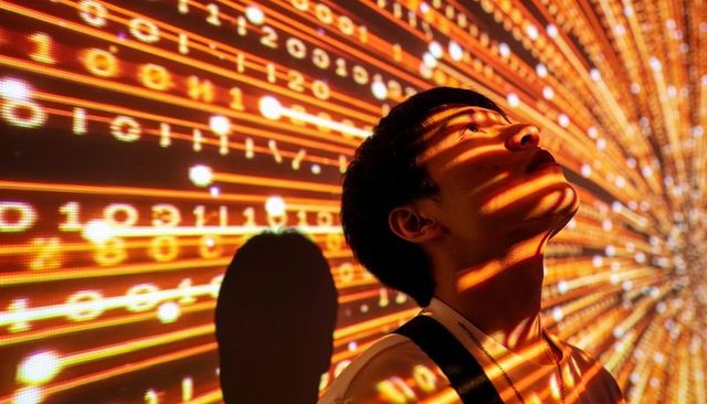 Asian man gazing into immersive binary light installation for futuristic data art