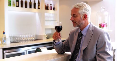 Middle-aged Professional Enjoying Red Wine at Modern Bar - Download Free Stock Images Pikwizard.com