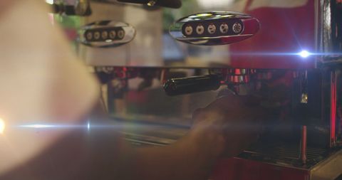 Professional Barista Operating Espresso Machine with Light Effects