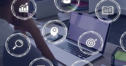 Business analysis with laptop and floating data icons, professional desk, digital strategy