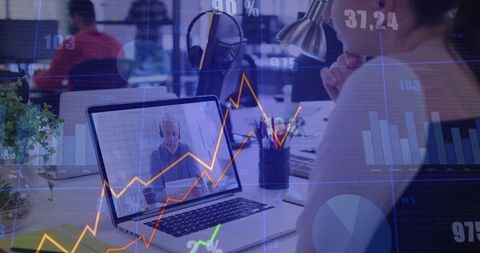 Watching remote meeting with senior consultant on laptop in open office with analytics