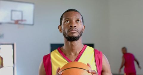 Focused Basketball Player Holding Ball in Gym, Ready for Game - Download Free Stock Images Pikwizard.com