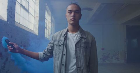 Confident Young Man with Colored Smoke in Urban Space - Download Free Stock Images Pikwizard.com