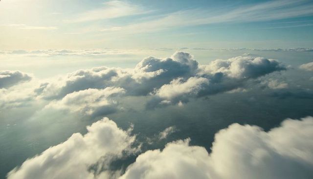 Sunlit Layered Clouds Floating Above Earth, Casting Soft Shadows Across Horizon