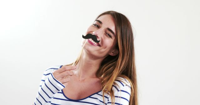 Young Woman with Fun Moustache Sticker Smiling Playfully - Download Free Stock Images Pikwizard.com