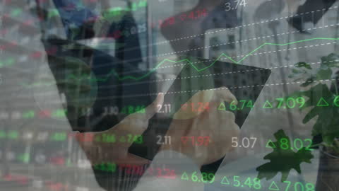 Businessman Analyzing Financial Data on Tablet with Graph Overlay