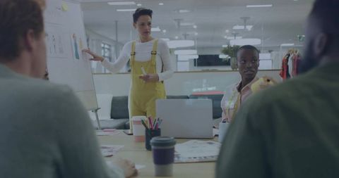 Creative woman leading brainstorming session in bright office