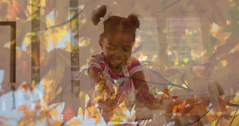 Joyful Child Sculpting with Autumn Leaves Overlay