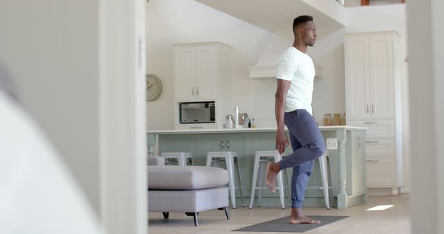 Man Practicing Yoga in Modern Home Kitchen - Download Free Stock Images Pikwizard.com