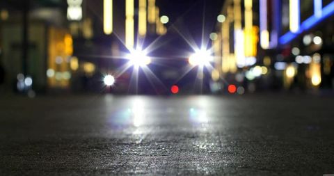 Starburst headlights in urban night street scene
