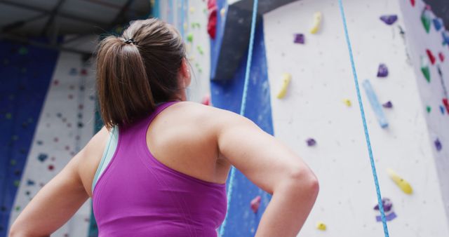 Woman Contemplating Indoor Rock Climbing Wall - Download Free Stock Images Pikwizard.com