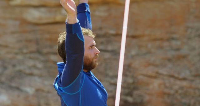 Man Stretching Outdoors Against Rocky Background - Download Free Stock Images Pikwizard.com