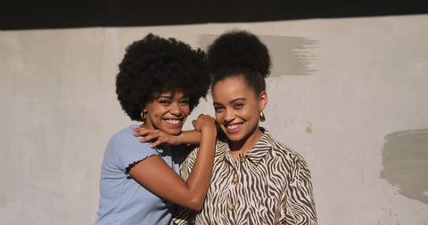 Joyful Biracial Twin Sisters Embracing Outdoors