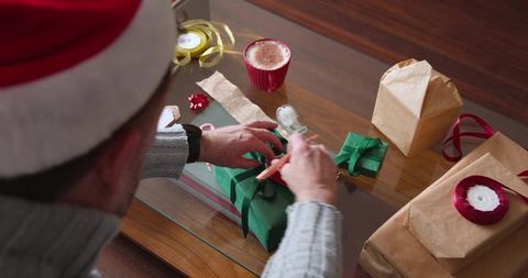 Senior man wrapping gift for festive celebration