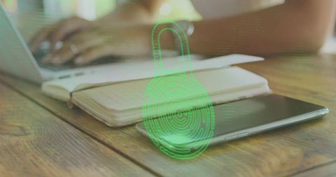 Protecting mobile data green fingerprint padlock hologram over smartphone and notebook