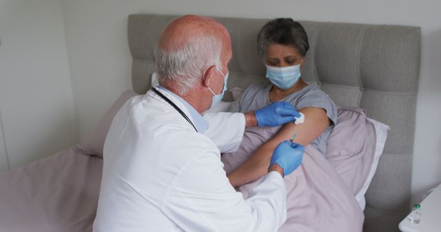 Doctor Administering Vaccine to Senior Patient in Bed - Download Free Stock Images Pikwizard.com