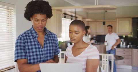 Diverse Friends Working Together in Home Kitchen Environment