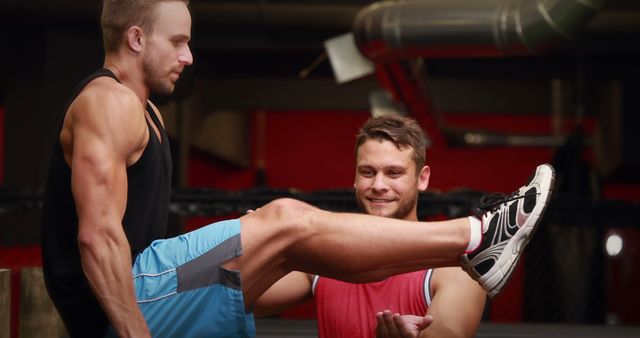 Personal Trainer Assisting Male Client with Leg Raises in Gym - Download Free Stock Images Pikwizard.com