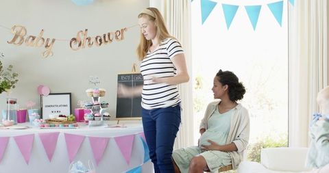 Diverse Female Friends Celebrating Baby Shower in Sunny Living Room
