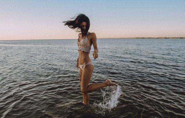 Woman Wearing Bikini Barefoot Standing on Sea Under Blue Sky - Download Free Stock Photos Pikwizard.com