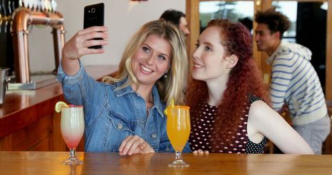 Friends Capturing Fun Moments at a Modern Bar - Download Free Stock Images Pikwizard.com