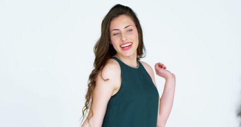 Cheerful female model posing in studio for fashion shoot