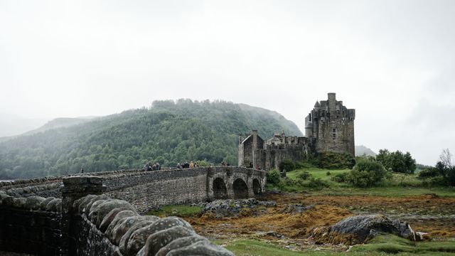 Ancient Castle with Stone Bridge in Misty Highland Scenery - Download Free Stock Photos Pikwizard.com