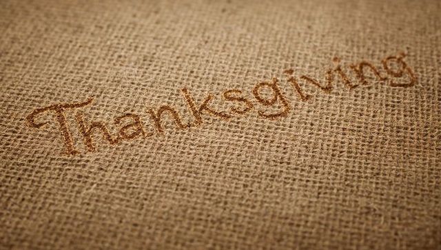 Scorching thanksgiving lettering on burlap texture, rustic jute harvest background