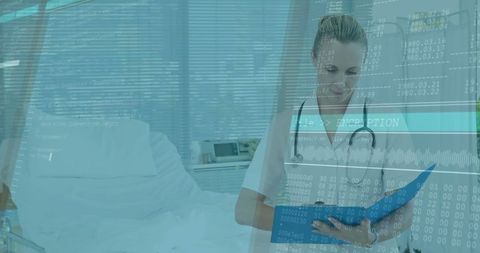 Healthcare professional reviewing digital data in hospital room