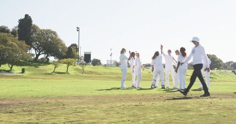 Female Cricketers Celebrating Under Sunny Skies