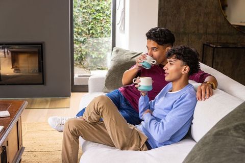 Casual Male Friends Enjoying Coffee in Contemporary Living Room
