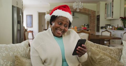 Woman in Santa Hat Joyfully Video Chatting During Christmas