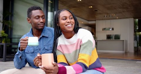 Happy Couple Enjoying Coffee on Contemporary Patio