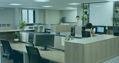 Employees collaborating in modern open-plan office workspace