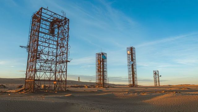 Abandoned multipurpose lattice towers in arid desert exploration