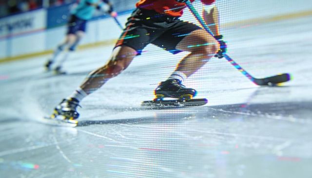 Skating hockey player pushing into turn on ice close-up, high-speed action and motion blur