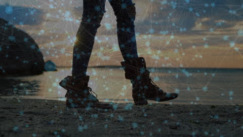 Woman Walking on Beach with Digital Network Overlay